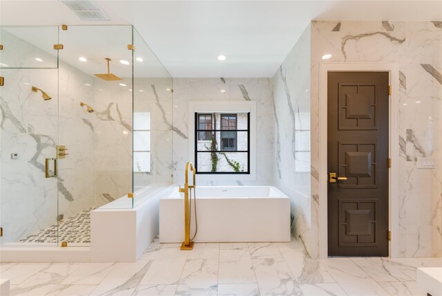 3713 Greenbrier Dr, University Park, TX 75225 - bathroom featuring marble finish flooring, a marble finish shower, a soaking tub, stone wall, and recessed lighting