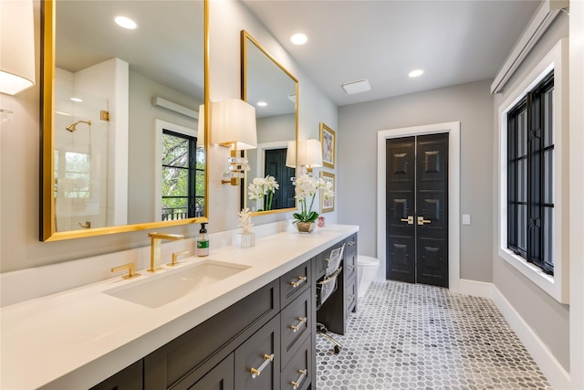 3713 Greenbrier Dr, University Park, TX 75225 - full bathroom featuring vanity, toilet, a tile shower, baseboards, and recessed lighting