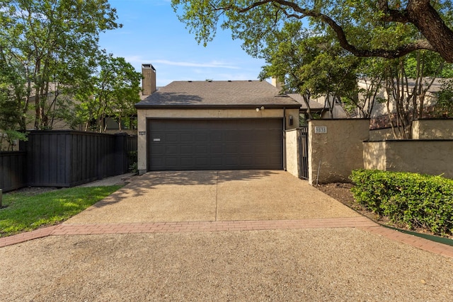 9838 Baseline Dr, Dallas, TX 75243 - view of front of property featuring concrete driveway, stucco siding, fence, and a chimney