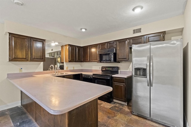 9838 Baseline Dr, Dallas, TX 75243 - kitchen with black appliances, a sink, light countertops, a peninsula, and dark brown cabinets