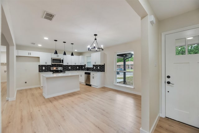 3011 Sunnybrook Ln, Arlington, TX 76014 - kitchen featuring stainless steel appliances, a chandelier, white cabinets, backsplash, and recessed lighting