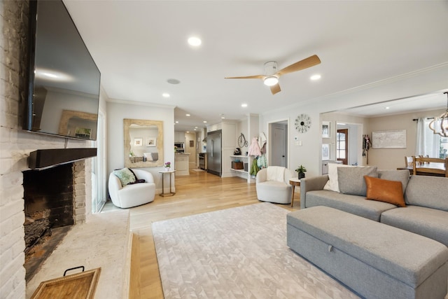 7008 Joyce Way, Dallas, TX 75225 - living area with ornamental molding, light wood-type flooring, a large fireplace, a ceiling fan, and recessed lighting