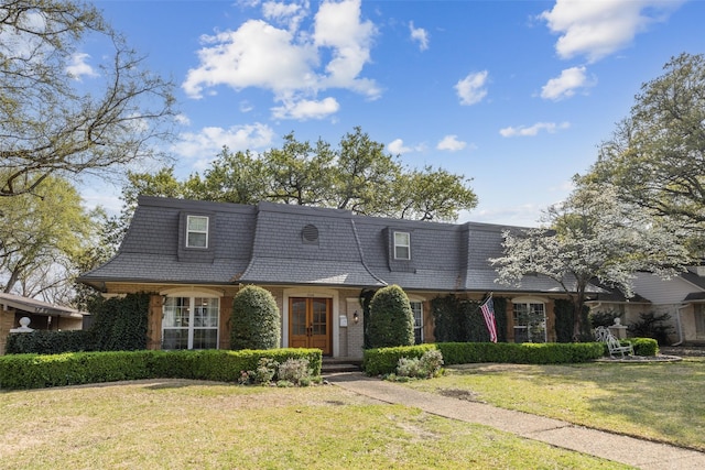 7008 Joyce Way, Dallas, TX 75225 - view of front of house featuring mansard roof, a front yard, french doors, and brick siding