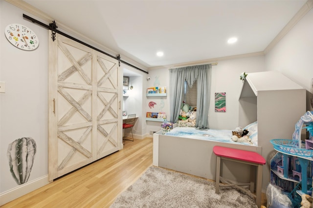 7008 Joyce Way, Dallas, TX 75225 - recreation room featuring a barn door, wood finished floors, recessed lighting, ornamental molding, and baseboards