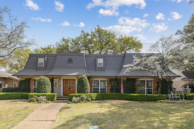 7008 Joyce Way, Dallas, TX 75225 - view of front of home with mansard roof, a front yard, french doors, and brick siding