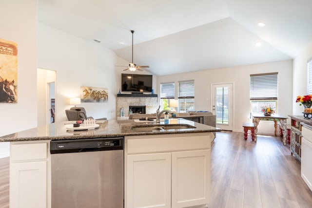 513 Lake Cove Dr, Little Elm, TX 75068 - kitchen featuring stainless steel dishwasher, open floor plan, a stone fireplace, a ceiling fan, and light wood-style floors
