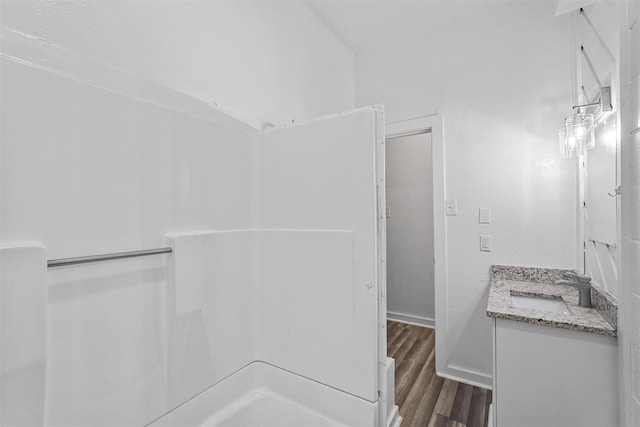 401 E Buffalo St, Forney, TX 75126 - bathroom with vanity, wood finished floors, and a shower