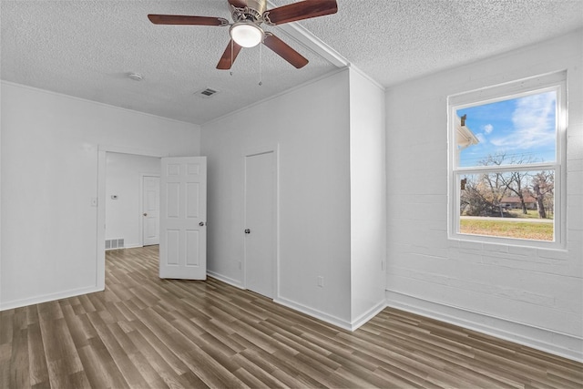 401 E Buffalo St, Forney, TX 75126 - unfurnished bedroom featuring wood finished floors, a textured ceiling, baseboards, and ceiling fan