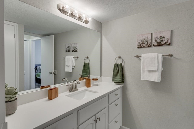 15151 Berry Trl Unit 401, Dallas, TX 75248 - bathroom featuring vanity and a textured ceiling