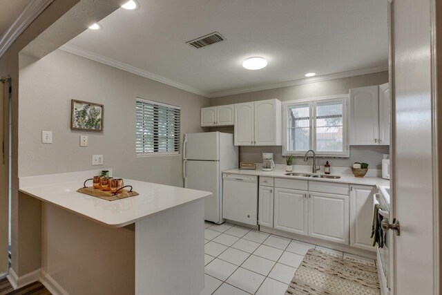15151 Berry Trl Unit 401, Dallas, TX 75248 - kitchen with a sink, white appliances, a peninsula, ornamental molding, and white cabinets