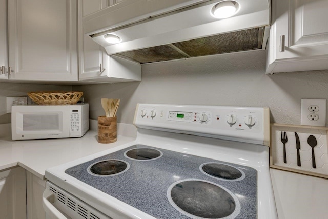 15151 Berry Trl Unit 401, Dallas, TX 75248 - kitchen view of white appliances, under cabinet range hood, light countertops, and white cabinets