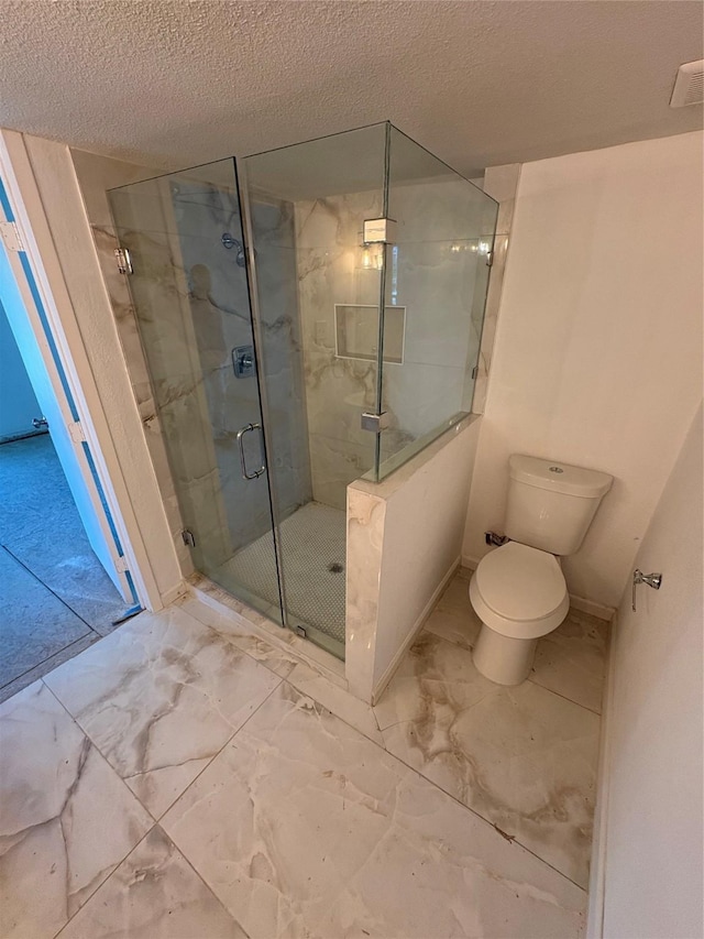 401 S Bois D Arc St, Forney, TX 75126 - full bath featuring marble look tile flooring, a textured ceiling, toilet, and a stall shower