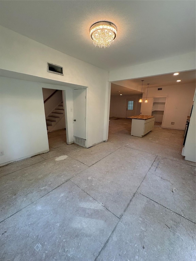 401 S Bois D Arc St, Forney, TX 75126 - unfurnished living room featuring stairway and a chandelier