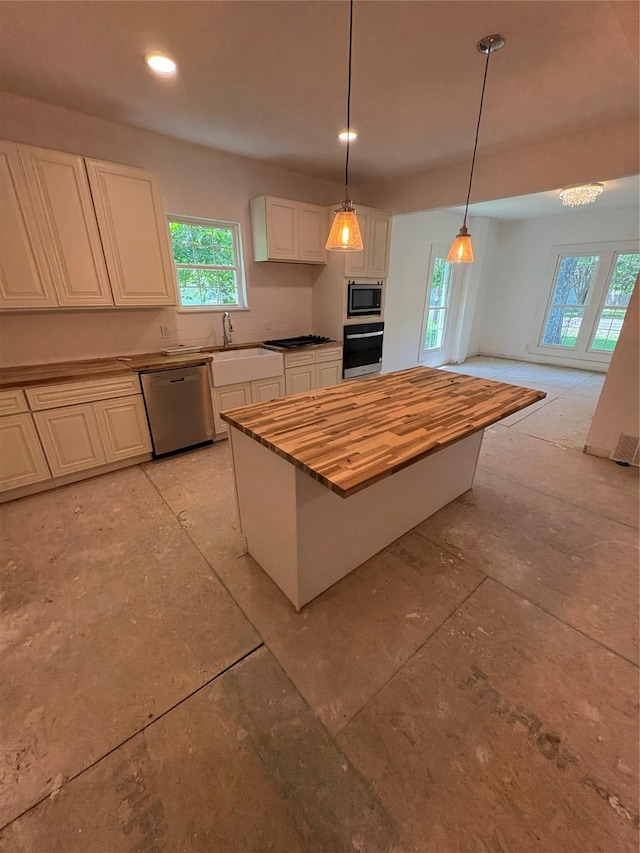 401 S Bois D Arc St, Forney, TX 75126 - kitchen with wall oven, built in microwave, dishwasher, wood counters, and white cabinetry