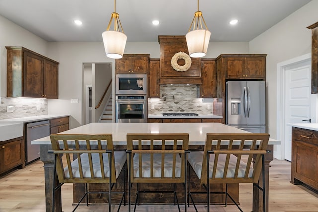kitchen featuring appliances with stainless steel finishes, decorative backsplash, light countertops, and recessed lighting