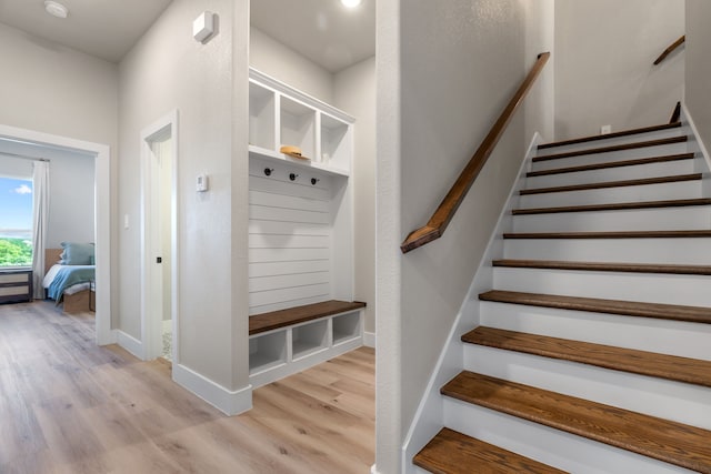 mudroom with light wood-type flooring and baseboards