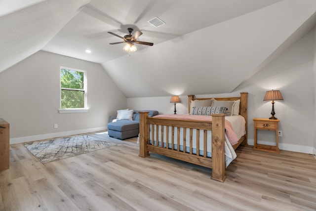 bedroom with baseboards, wood finished floors, vaulted ceiling, and ceiling fan