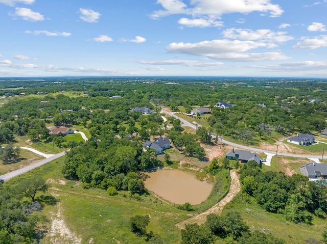 aerial view of property and surrounding area with a heavily wooded area
