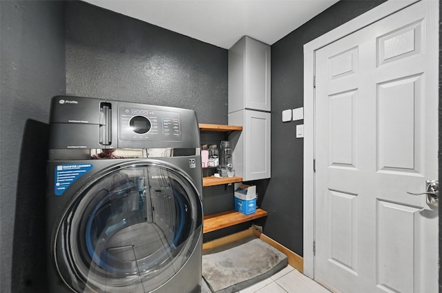 4524 Rosedale Dr, Grand Prairie, TX 75052 - laundry area with washer / clothes dryer, cabinet space, tile patterned floors, and a textured wall