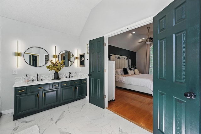 4524 Rosedale Dr, Grand Prairie, TX 75052 - bathroom with lofted ceiling, a ceiling fan, ensuite bathroom, marble look tile flooring, and double vanity