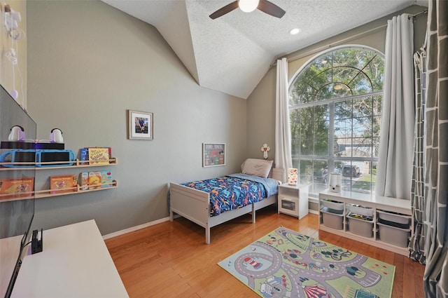 4524 Rosedale Dr, Grand Prairie, TX 75052 - bedroom featuring lofted ceiling, a textured ceiling, wood finished floors, a ceiling fan, and baseboards