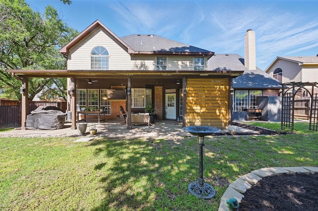 4524 Rosedale Dr, Grand Prairie, TX 75052 - back of house featuring a patio area, brick siding, a ceiling fan, and a chimney
