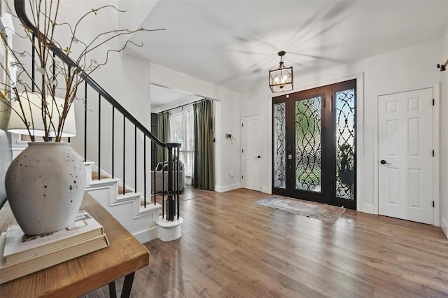 4524 Rosedale Dr, Grand Prairie, TX 75052 - entrance foyer featuring wood finished floors, stairway, baseboards, and a chandelier