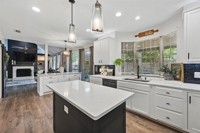 4524 Rosedale Dr, Grand Prairie, TX 75052 - kitchen featuring a center island, a sink, a fireplace, tasteful backsplash, and black dishwasher