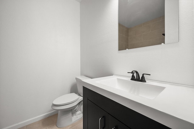 710 E 3rd Ave, Corsicana, TX 75110 - bathroom featuring vanity, toilet, tile patterned flooring, and baseboards