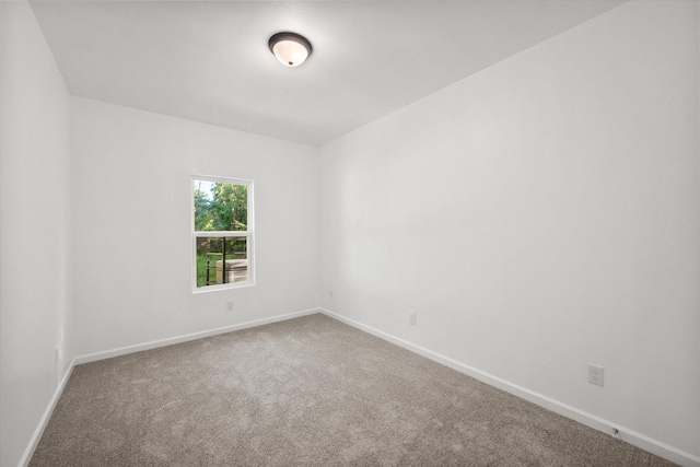 710 E 3rd Ave, Corsicana, TX 75110 - spare room featuring carpet and baseboards