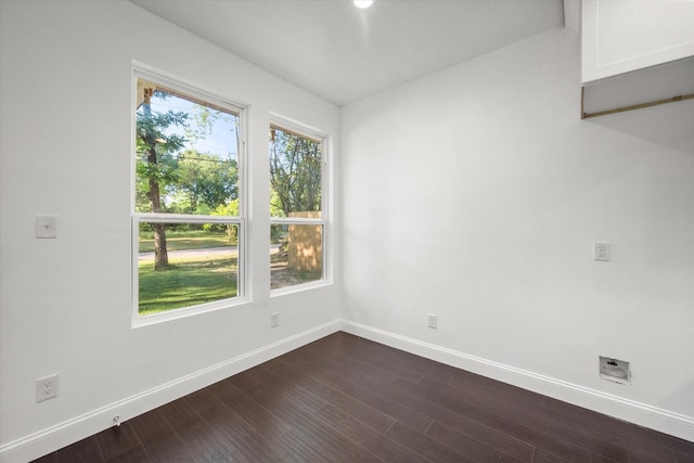 710 E 3rd Ave, Corsicana, TX 75110 - spare room featuring baseboards and dark wood-style floors