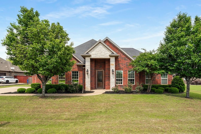 958 Prairie Timber Rd, Burleson, TX 76028 - traditional home featuring brick siding, a front lawn, and a shingled roof