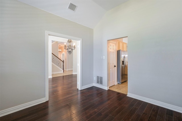 11212 Sunrise Ln, Frisco, TX 75035 - spare room with a chandelier, lofted ceiling, wood finished floors, baseboards, and stairs
