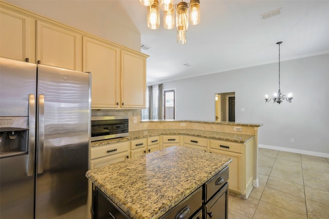 11212 Sunrise Ln, Frisco, TX 75035 - kitchen with appliances with stainless steel finishes, cream cabinets, a chandelier, light stone counters, and light tile patterned flooring