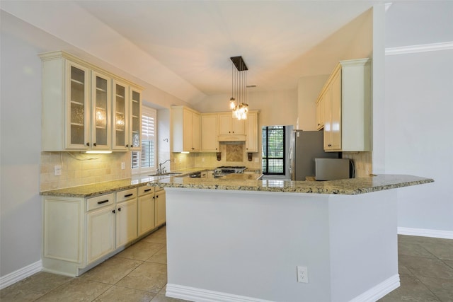 11212 Sunrise Ln, Frisco, TX 75035 - kitchen featuring plenty of natural light, appliances with stainless steel finishes, backsplash, and light stone counters