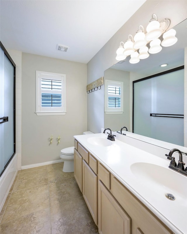 11212 Sunrise Ln, Frisco, TX 75035 - bathroom with toilet, baseboards, and double vanity