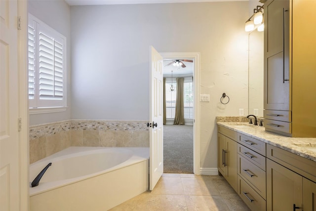 11212 Sunrise Ln, Frisco, TX 75035 - full bathroom featuring double vanity, ceiling fan, a garden tub, and tile patterned flooring