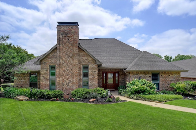 731 Falcon Ln, Coppell, TX 75019 - view of front facade with brick siding, roof with shingles, a front lawn, and a chimney
