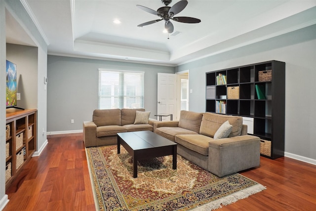731 Falcon Ln, Coppell, TX 75019 - living room with a tray ceiling, a ceiling fan, dark wood-style flooring, baseboards, and crown molding