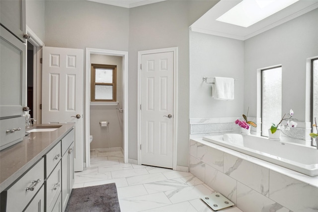 731 Falcon Ln, Coppell, TX 75019 - bathroom featuring toilet, marble look tiles, a skylight, a bath, and crown molding