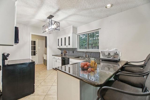 611 Buffalo Dr, Arlington, TX 76013 - kitchen featuring a sink, dishwasher, white cabinetry, light tile patterned flooring, and a chandelier