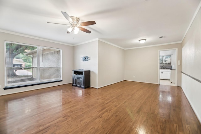 611 Buffalo Dr, Arlington, TX 76013 - unfurnished living room with ceiling fan, wood finished floors, ornamental molding, and baseboards