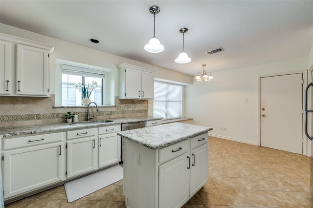 1404 Chicota Dr, Plano, TX 75023 - kitchen with a sink, backsplash, white cabinets, and a kitchen island