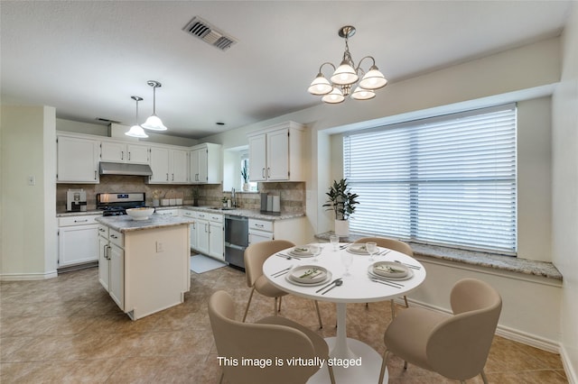 1404 Chicota Dr, Plano, TX 75023 - kitchen featuring under cabinet range hood, appliances with stainless steel finishes, a sink, and backsplash