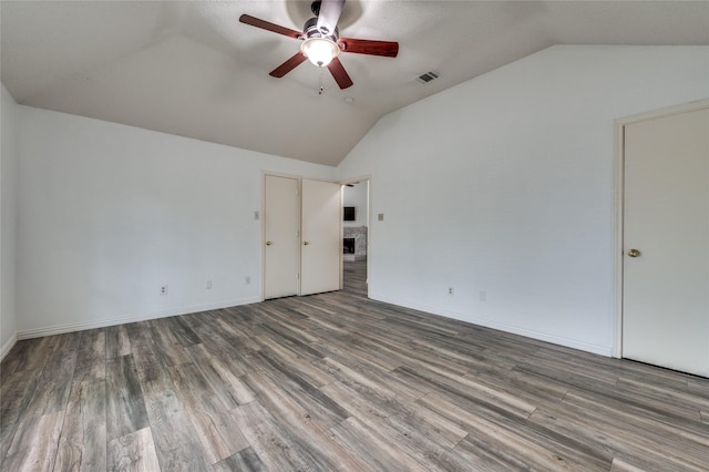 1404 Chicota Dr, Plano, TX 75023 - spare room featuring vaulted ceiling, ceiling fan, wood finished floors, and baseboards