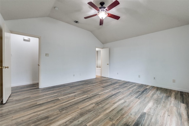 1404 Chicota Dr, Plano, TX 75023 - spare room with lofted ceiling, ceiling fan, wood finished floors, and baseboards