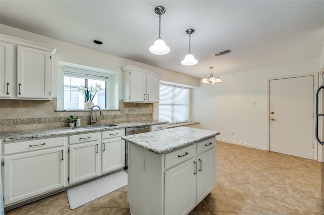 1404 Chicota Dr, Plano, TX 75023 - kitchen featuring a sink, decorative backsplash, white cabinets, and a kitchen island