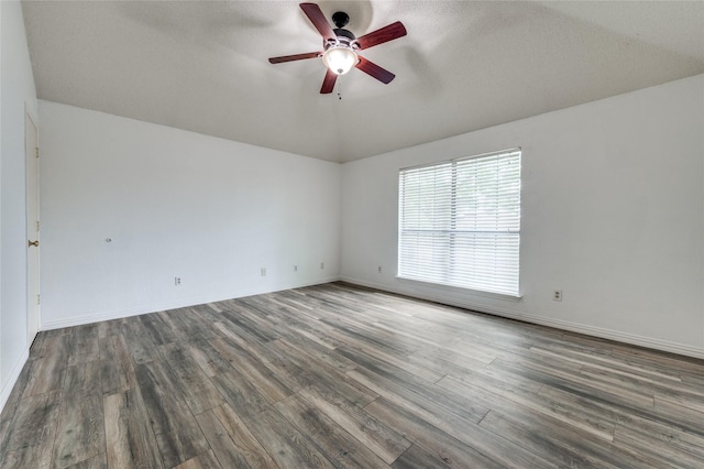 1404 Chicota Dr, Plano, TX 75023 - spare room with a ceiling fan, wood finished floors, baseboards, vaulted ceiling, and a textured ceiling