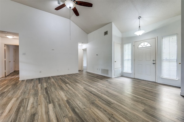 1404 Chicota Dr, Plano, TX 75023 - foyer featuring a ceiling fan, wood finished floors, high vaulted ceiling, baseboards, and a textured ceiling