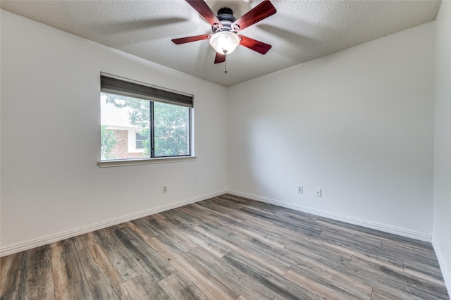 1404 Chicota Dr, Plano, TX 75023 - unfurnished room featuring wood finished floors, a ceiling fan, baseboards, and a textured ceiling